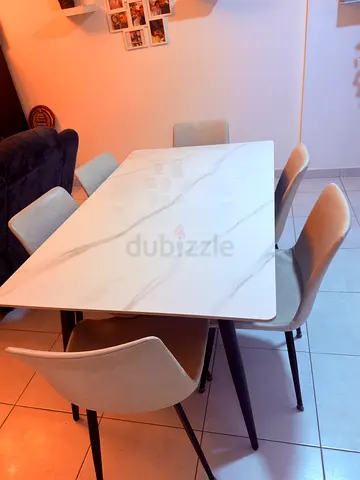 Light grey faux-leather dining chair with black metal legs