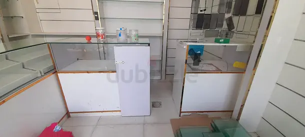 Used glass display counters and wall shelving set for retail shop