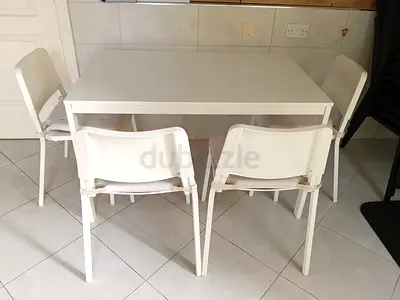 white extendable dining table with 4 chairs