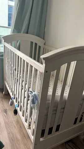 White wooden baby crib,