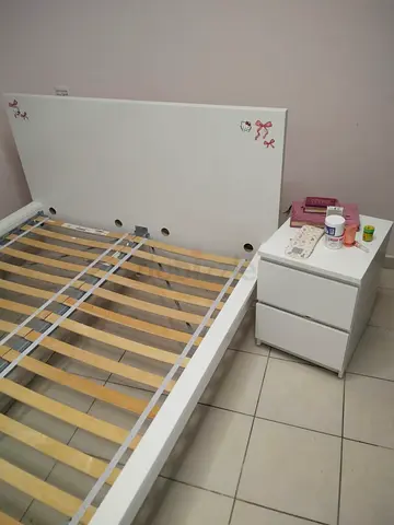 White wooden bed frame with two-drawer bedside table