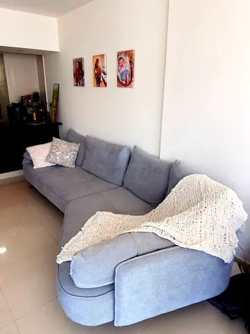 Light grey L-shaped fabric sofa — good condition