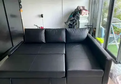 Black L-shaped convertible sofa bed (good condition)