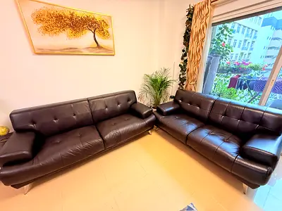 Set of two dark brown leather sofas — modern, good condition (3 and 2 Seater)
