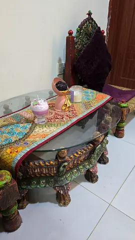 Hand-carved painted wooden coffee table with glass top