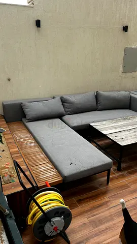 L-shaped outdoor sectional sofa with wooden side panel and armchair - used