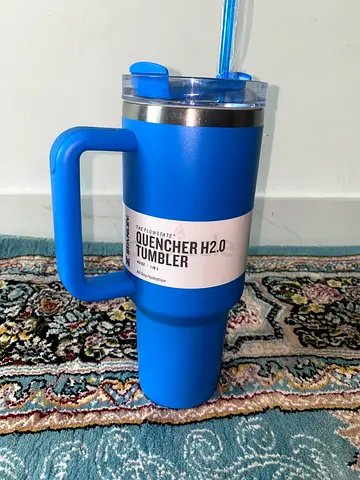 Blue insulated Stanley tumbler cup with handle and straw
