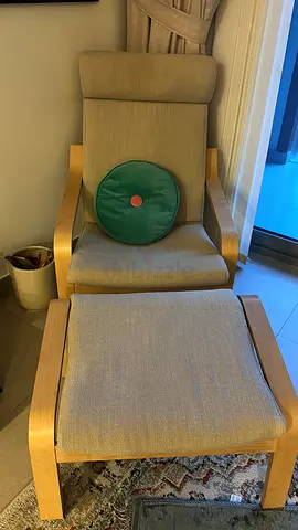 Wood-framed high-back lounge chair with matching ottoman
