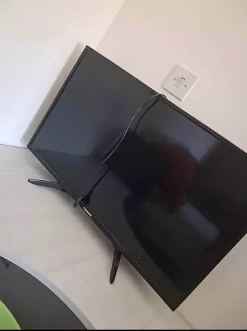 Used LED TV with stand and power cable — working condition