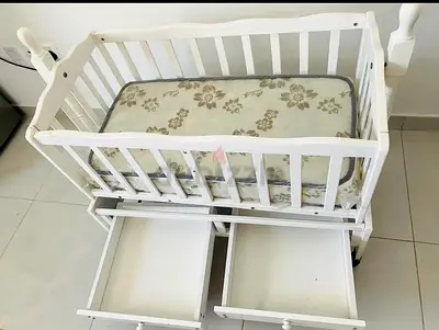 Selling my white wooden baby cradle with new mattress and two drawers