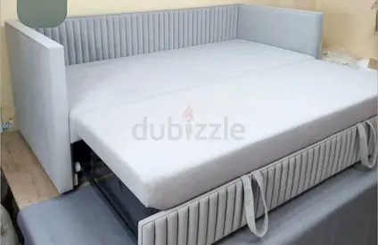 Light grey upholstered daybed/sofa with pull-out trundle