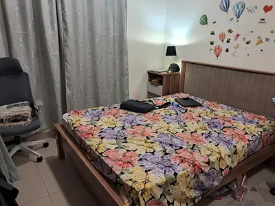 Wooden bed frame with upholstered headboard and bedside table