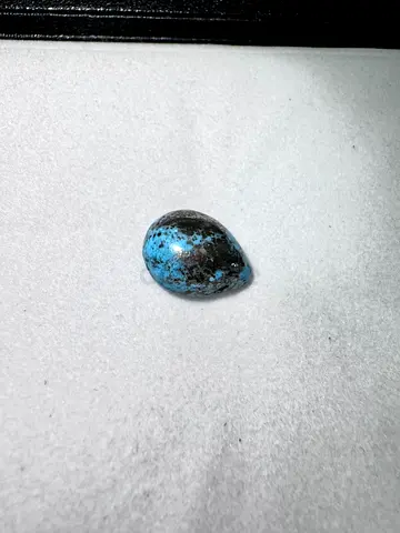 Polished blue-black teardrop cabochon (collectible mineral)