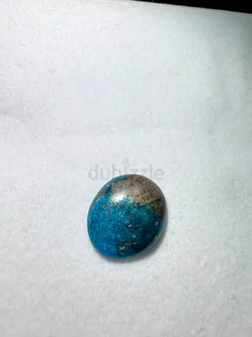 Polished blue-green mineral cabochon (likely chrysocolla/azurite)