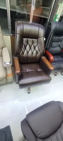 Brown leather reclining office/manager chair with wooden armrests