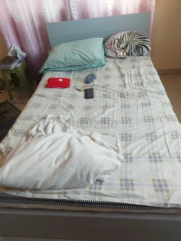Single bed with mattress and bedding