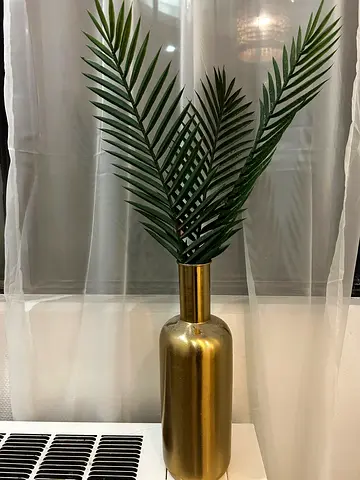 Gold tall vase with artificial palm leaves