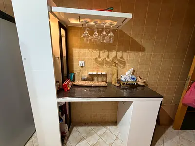 My white kitchen island with black countertop and wine glass rack