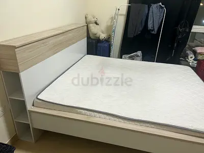 Queen-size bed frame with storage headboard and mattress