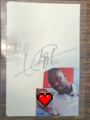 My autographed paper of sprinter usain bolt (with photo attached for authenticity)