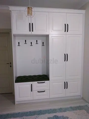 White built-in hallway wardrobe with hooks and drawers