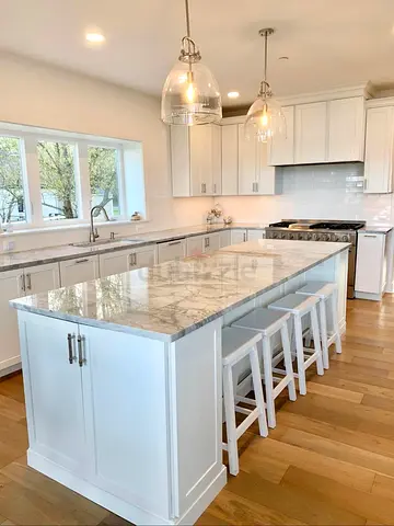 White kitchen island with marble-look countertop