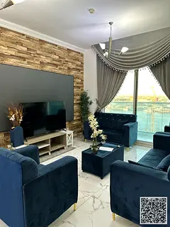 Luxury two-bedroom apartment with a living room and balcony offering sea views, available for monthl