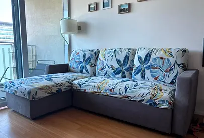 My L-shaped corner sofa with chaise - grey base and floral cushions