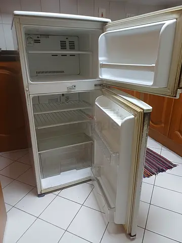 LG express cool refrigerator with top freezer — clean interior, some exterior wear