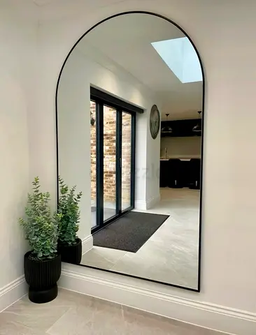 Large arched full-length wall mirror with black frame
