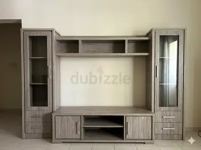 Grey wood TV entertainment wall unit with glass display cabinets