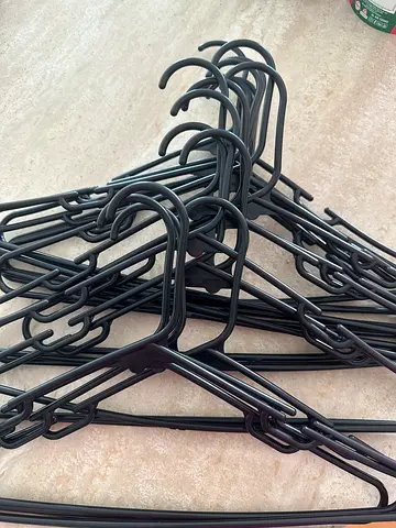 Bundle of black plastic clothes hangers