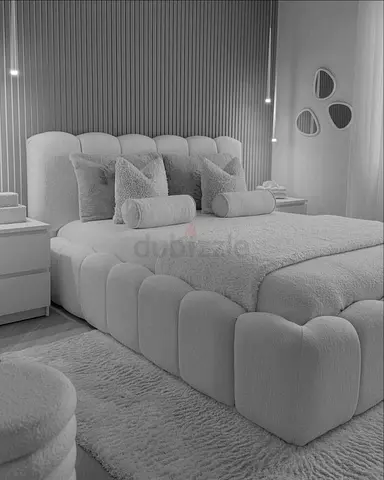Bouclé upholstered platform bed with padded headboard