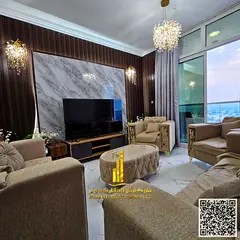 Luxury two-bedroom apartment with a living room and balcony offering sea views, available for monthl