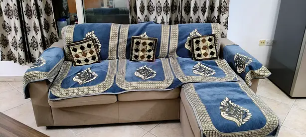 Beige L-shaped sectional sofa with blue cover set