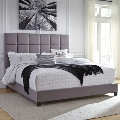 Gray upholstered bed frame with paneled headboard
