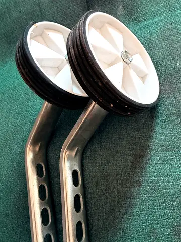 Pair of childrens bicycle training wheels with mounting brackets