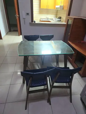 Im selling my glass-top 4-seater dining table with chairs