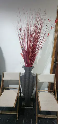 Tall grey floor vase with red dried branch arrangement