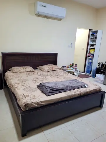 Solid wooden bed frame with headboard and mattress - used