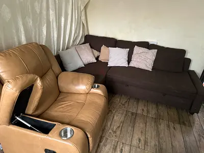 Brown L-shaped sofa with beige recliner armchair — used, good condition