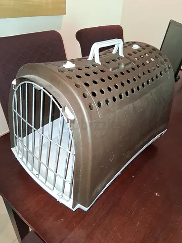 Used plastic pet carrier with metal front door