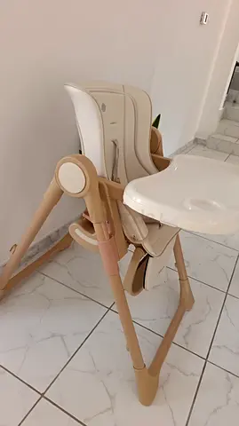 Adjustable beige baby high chair with removable tray