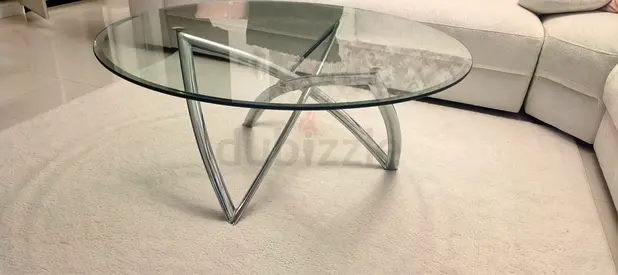 Round glass coffee table with chrome base