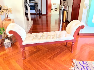 Cream tufted wooden bench with scroll arms