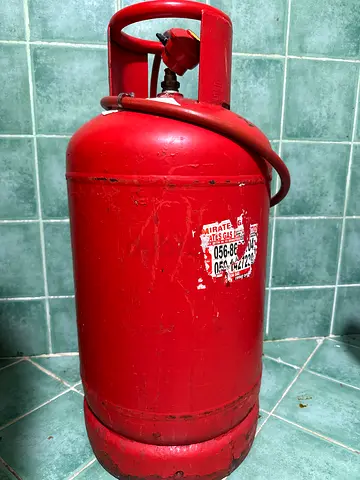 Used red LPG gas cylinder with knob - working condition