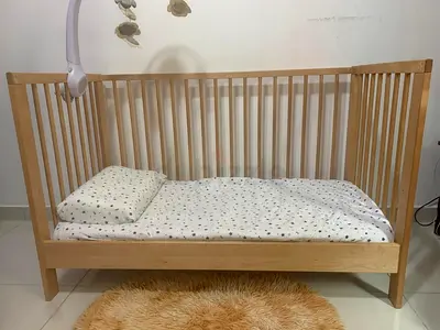 Light wood baby crib with mattress — gently used