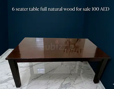 6 seater table made of natural wood along with 4 chairs for sale.