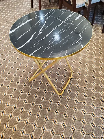 Round black marble-effect side table with gold folding base