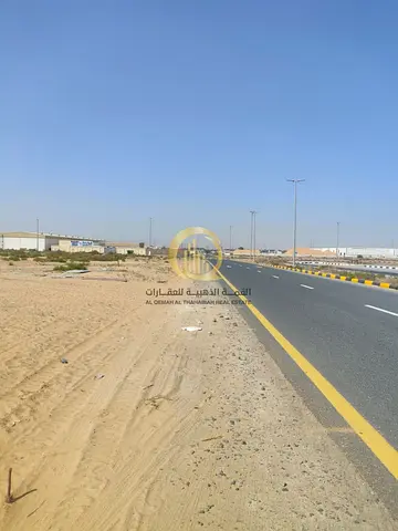 Industrial land for sale, freehold, open to all nationalities, area 22,900 sq ft, on a 36-meter wide main road, ready for immediate occupancy.